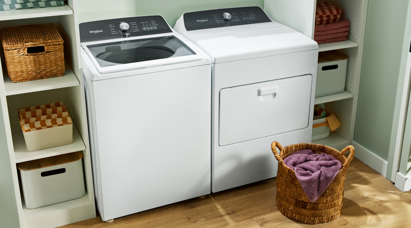 A Whirlpool® Top Load Washer and Front Load Dryer in a laundry room