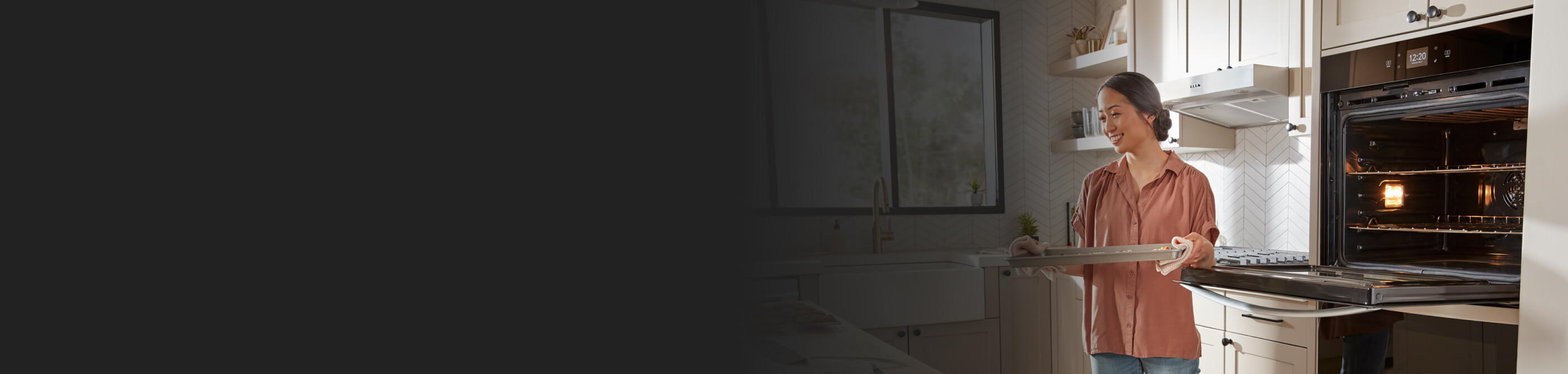 A person removing a tray from the oven