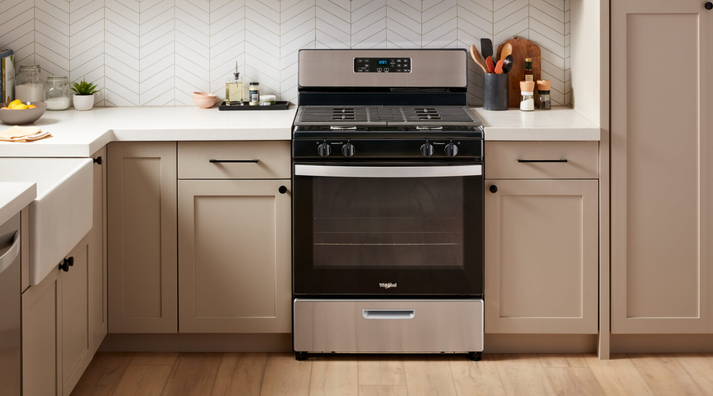 A Whirlpool® Range surrounded by tan cabinetry