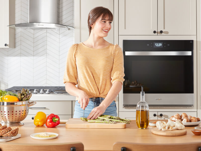 A person cutting asparagus A person cutting asparagus