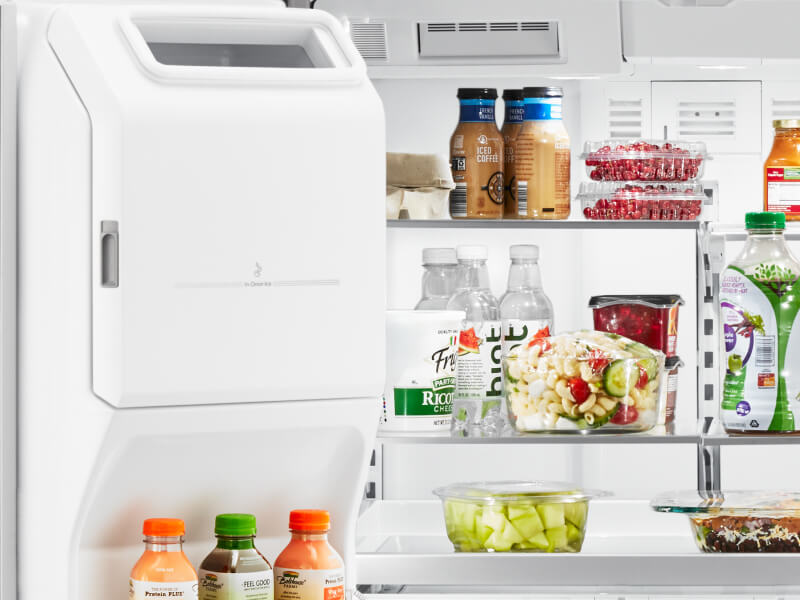 An open fridge door, showing various food products on the shelves An open fridge door, showing various food products on the shelves