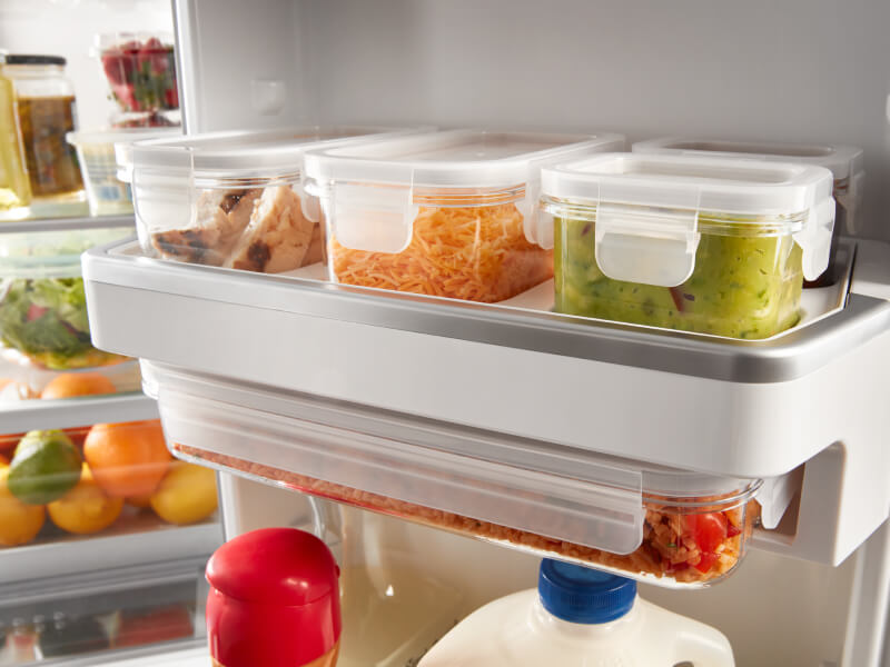 Food items in containers on a refrigerator shelf Food items in containers on a refrigerator shelf