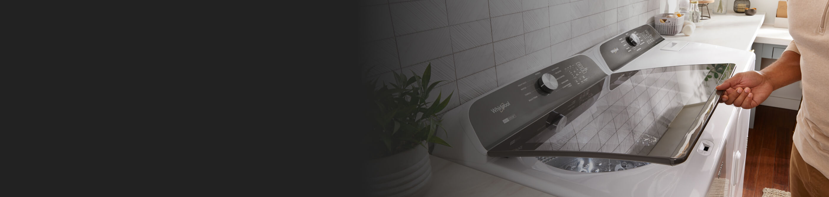 Person lifting the glass lid on a Whirlpool® Top Load Washer