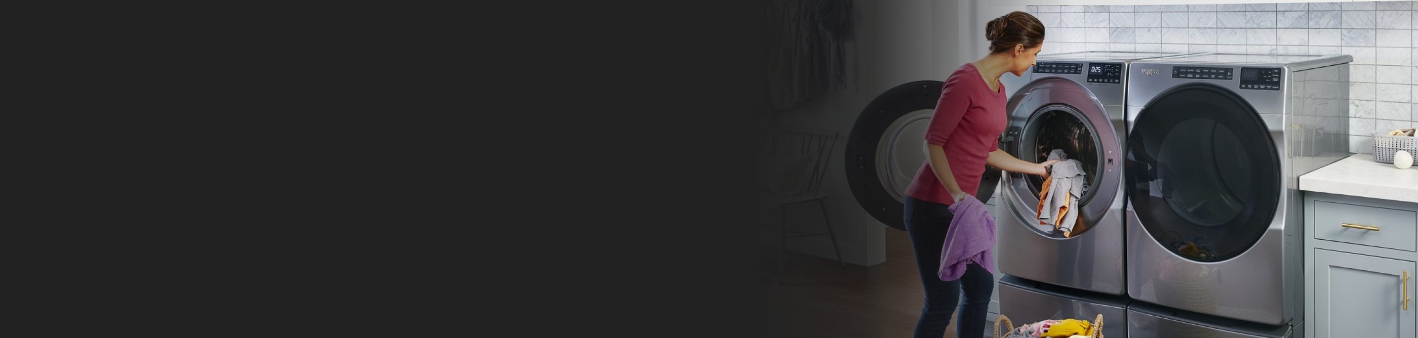 Woman loading clothing into front-load washer