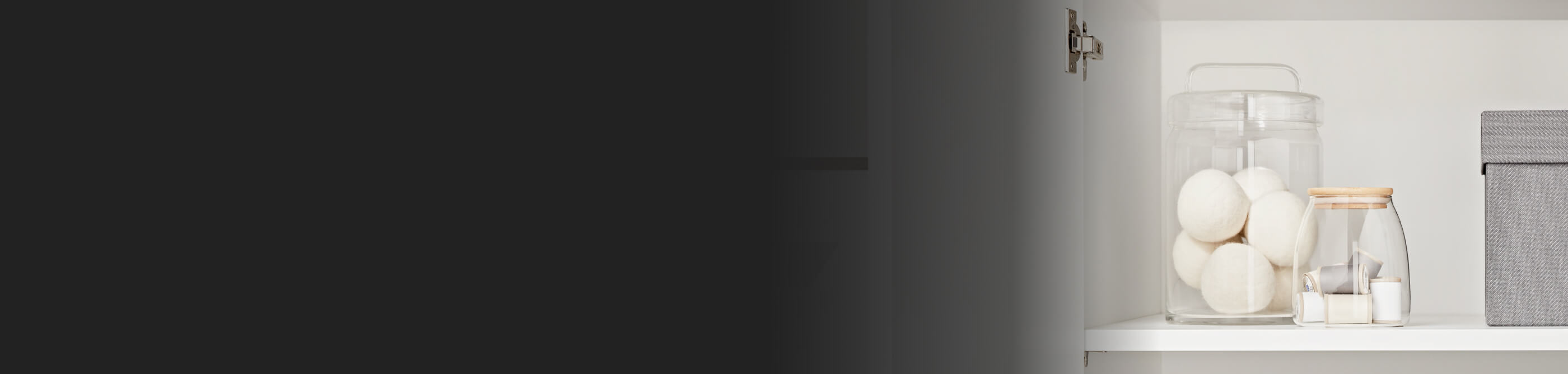 Wool dryer balls on a counter in a glass jar