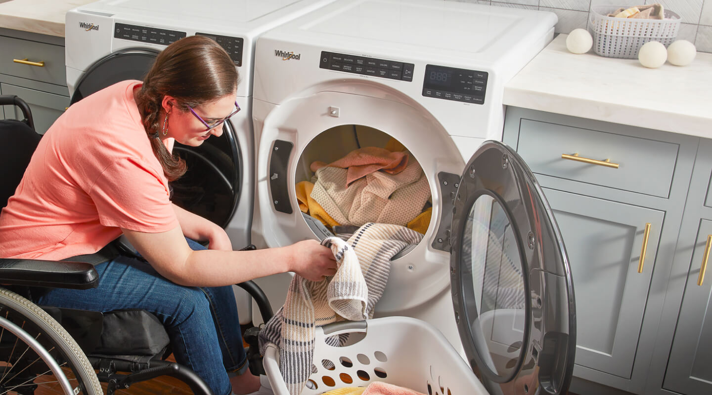 Person removing laundry from a dryer