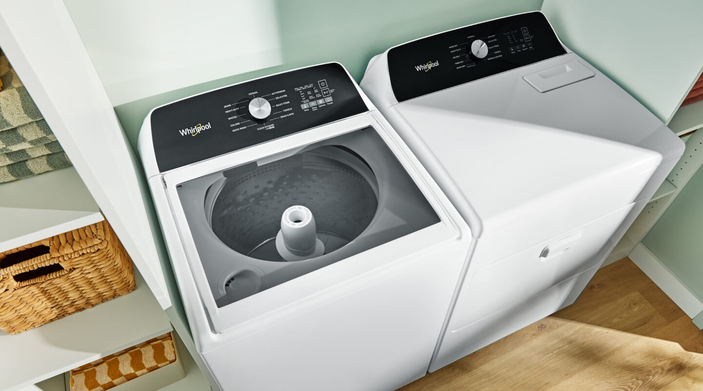 A Whirlpool® Top Load Washer and Front Load Dryer in a laundry room