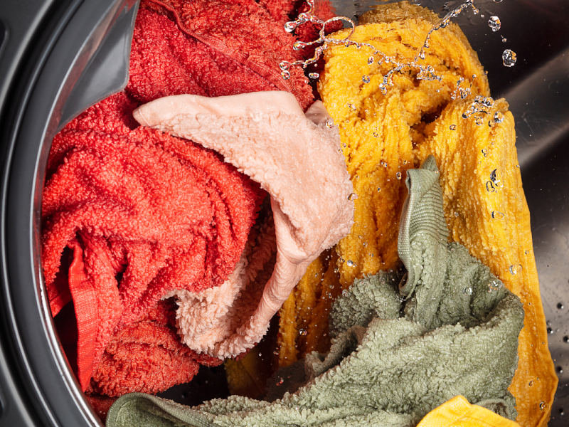 A closeup of laundry in a Whirlpool® washing machine. A closeup of laundry in a Whirlpool® washing machine.
