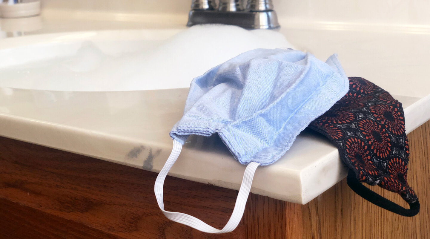 Cloth face masks next to a sink Cloth face masks next to a sink