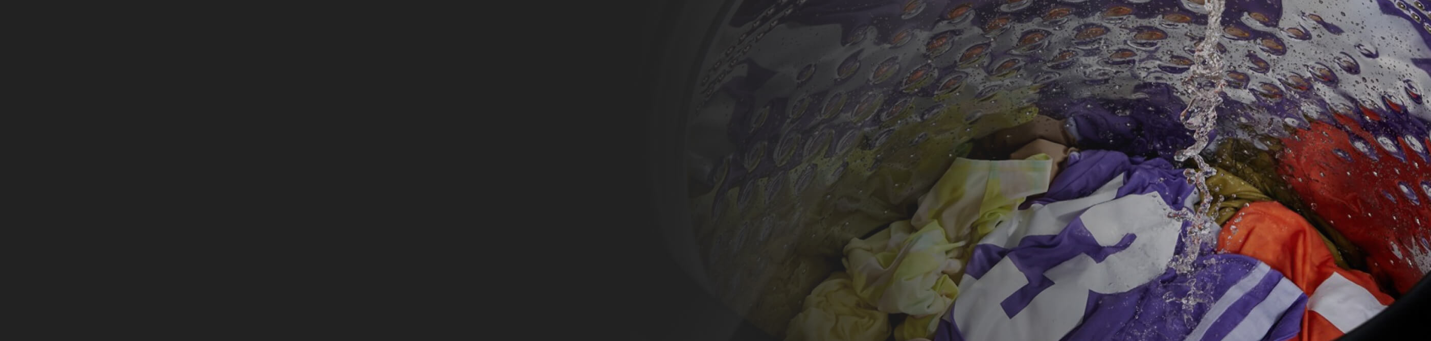 Close-up of water filling washer with jersey inside