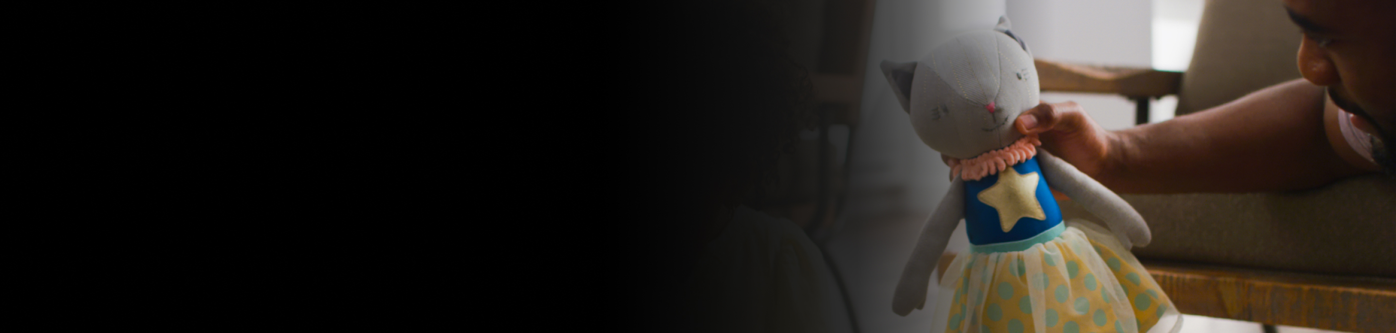 A person holding a stuffed animal