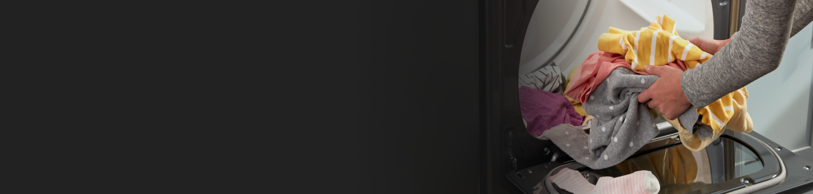 Towels being loaded into a dryer