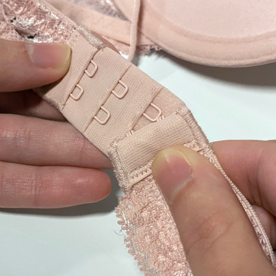 Person closing the hooks of a bra