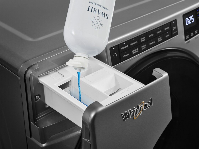 Swash detergent being poured into Whirlpool washer’s detergent dispenser. Swash detergent being poured into Whirlpool washer’s detergent dispenser.