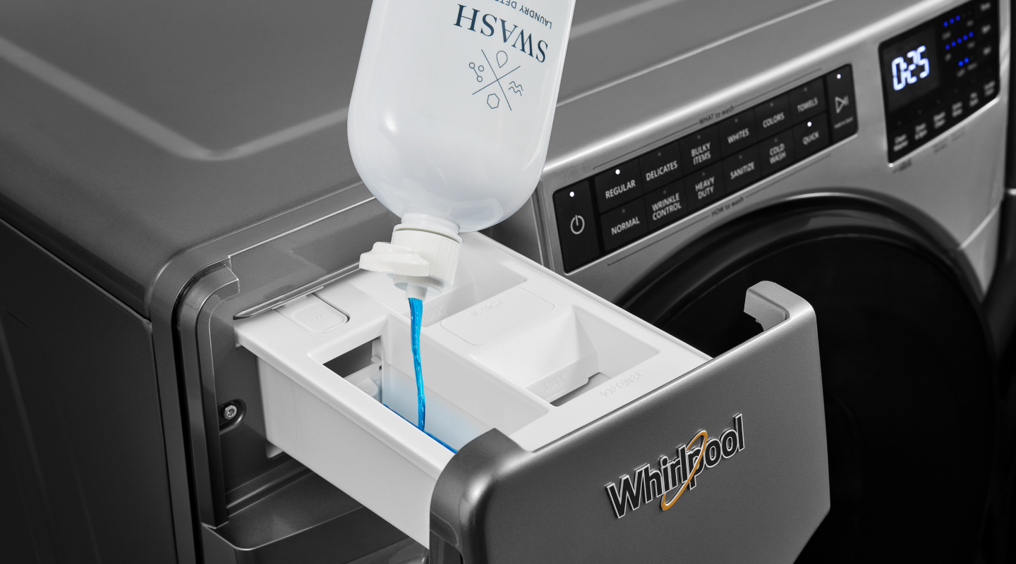 Swash® detergent being poured in a detergent drawer Swash® detergent being poured in a detergent drawer