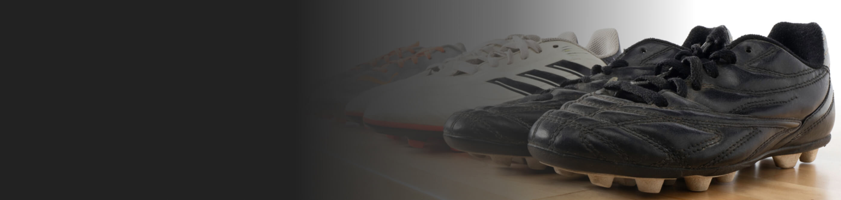 Various cleats lined up for cleaning
