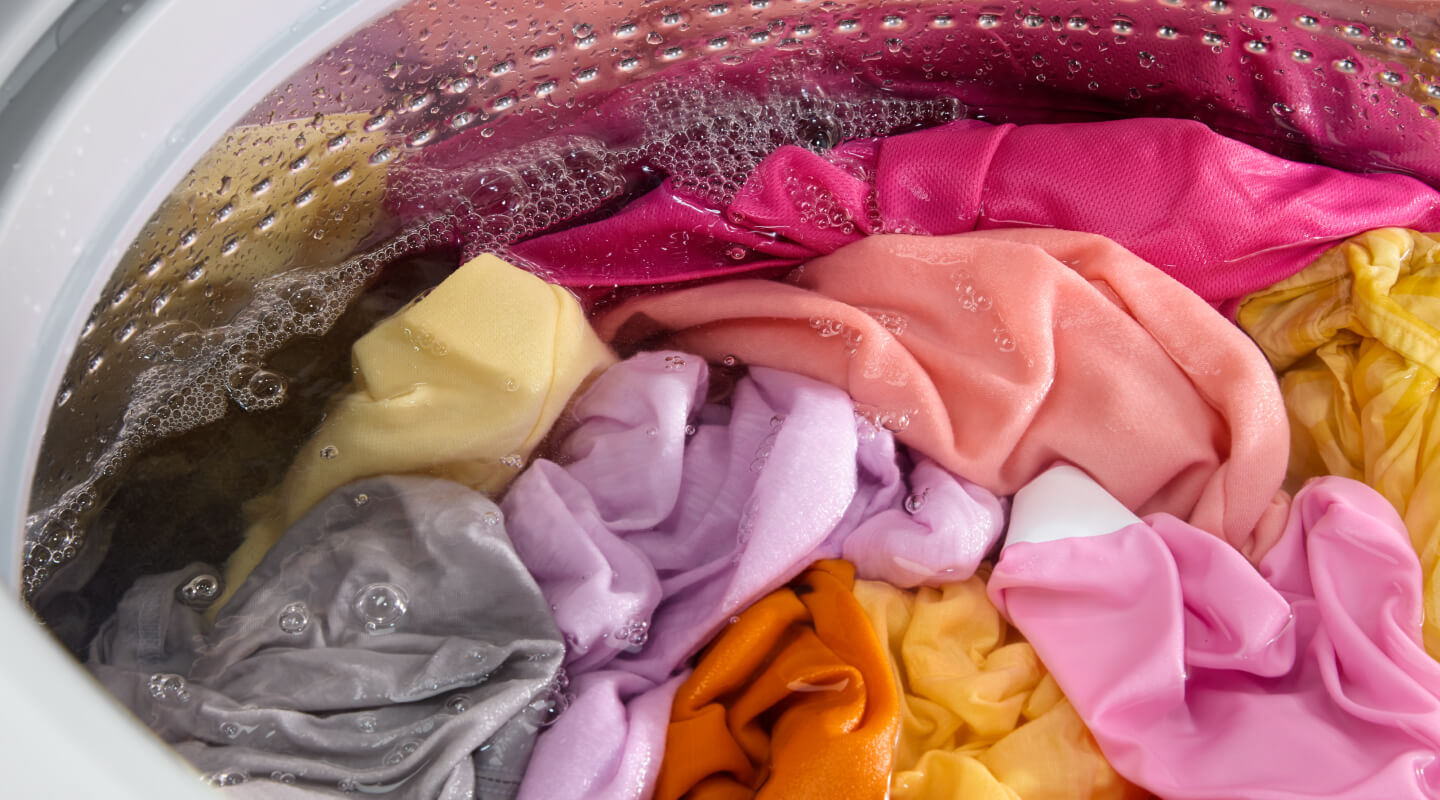 Brightly colored clothing in a washing machine Brightly colored clothing in a washing machine