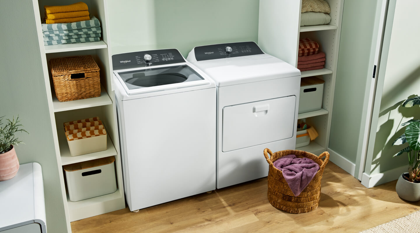 Laundry room with a white Whirlpool® Top Load Washer and Dryer Set 