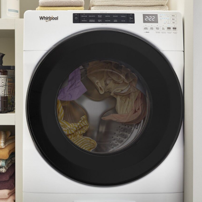 A running washer filled with clothes