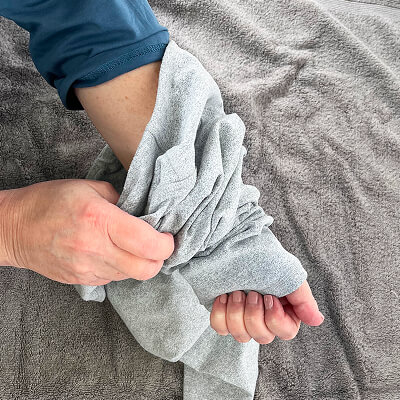 A person turning leggings inside out