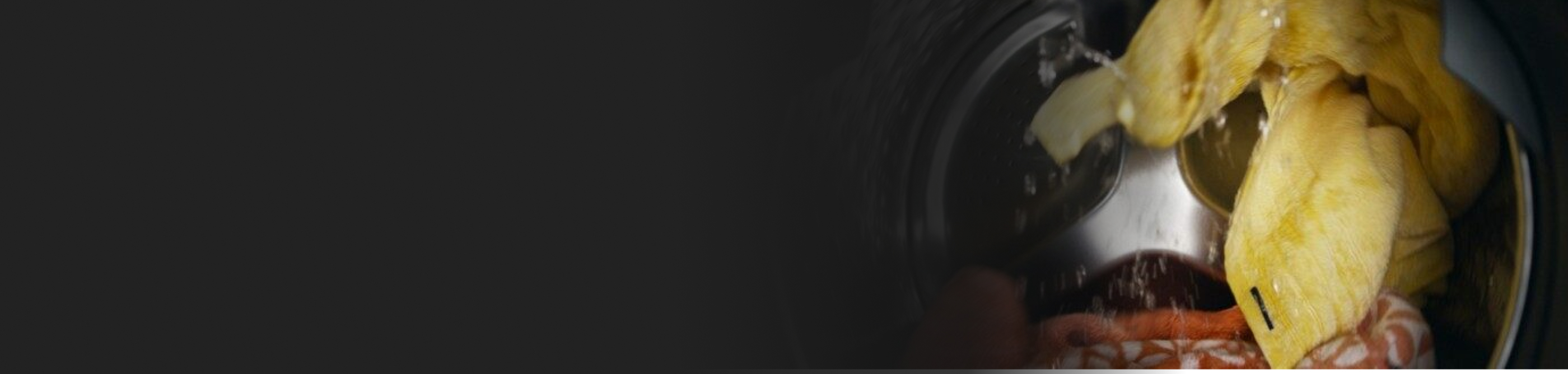 Brightly colored towels being washed inside a washer