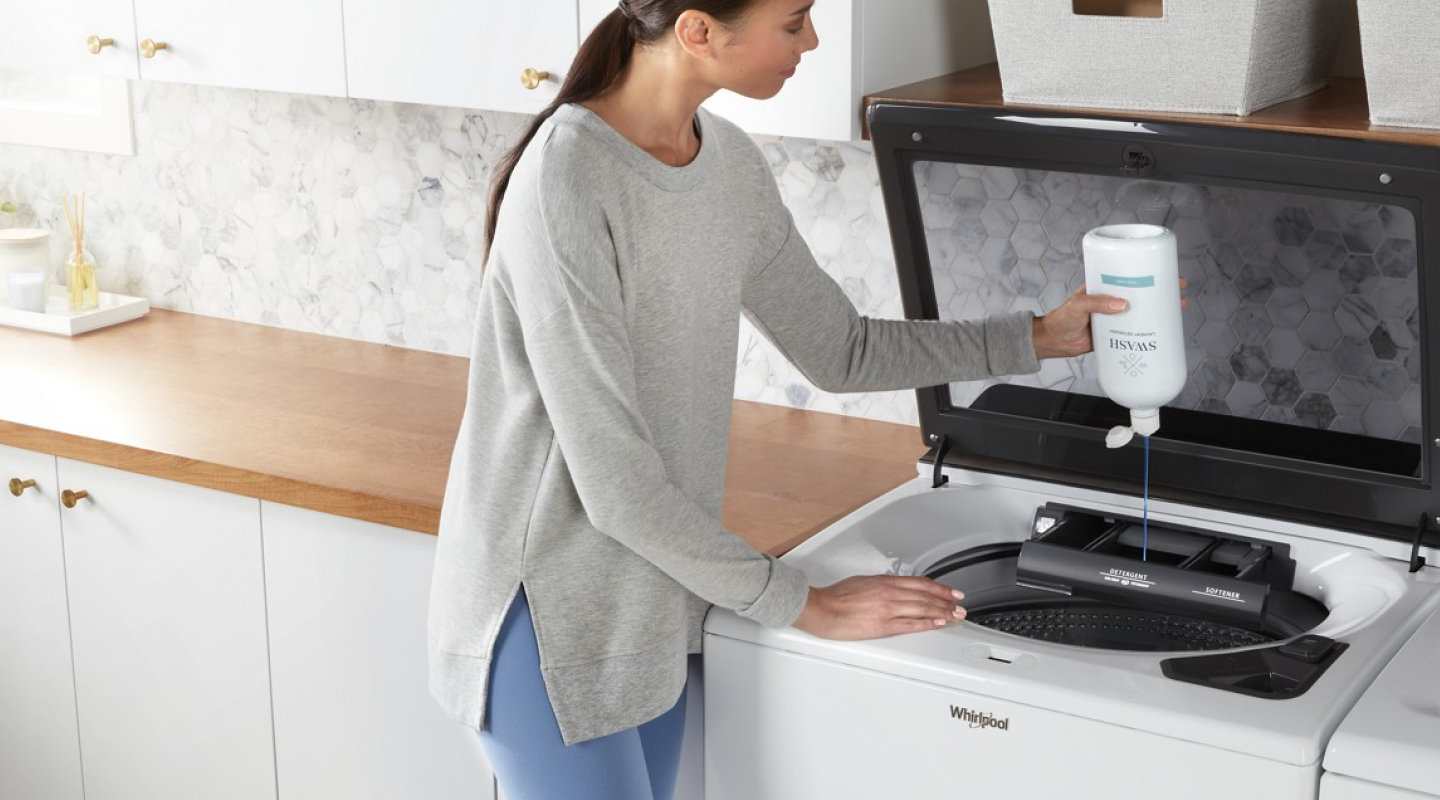 Person adding Swash® to a washing machine Person adding Swash® to a washing machine
