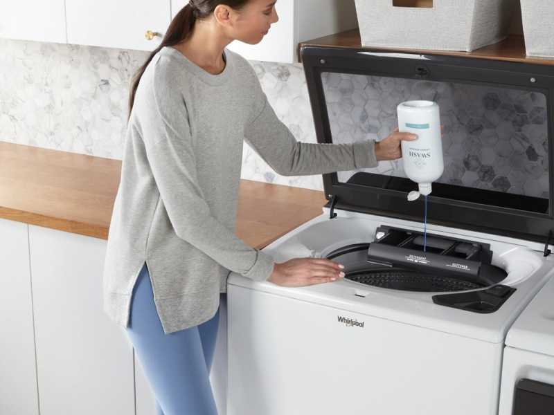 Person adding Swash® to a washing machine Person adding Swash® to a washing machine