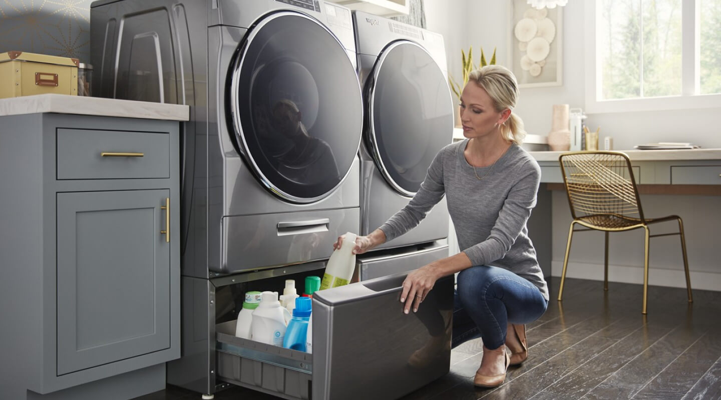 Woman putting an item in her washer pedestal
