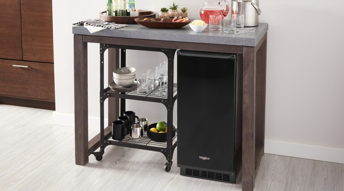 Black Whirlpool® Ice Maker under stand-alone drink bar