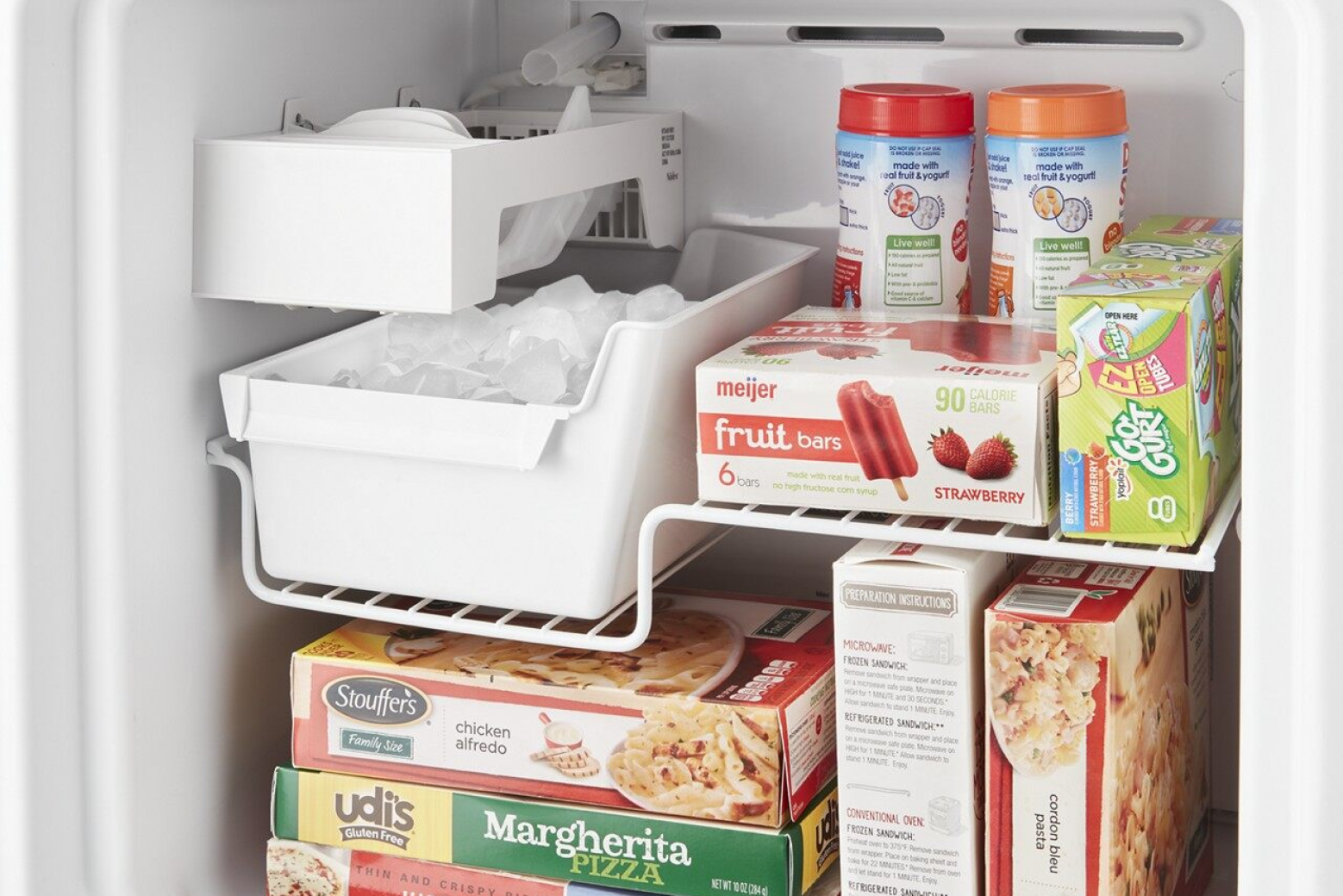 Close-up of full ice maker bin inside of freezer compartment