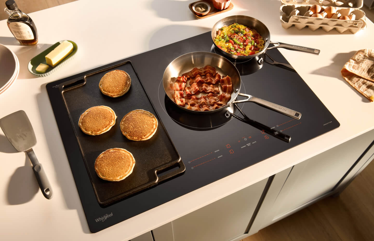 Breakfast foods cooking on Whirlpool® Induction Stovetop