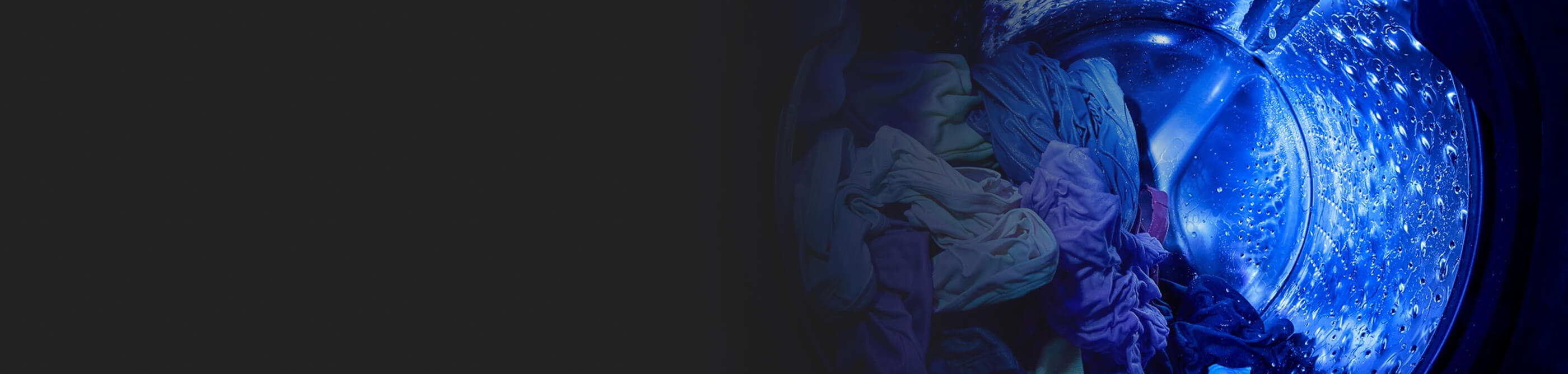Blue light from UV Clean Technology in a Whirlpool® Washer shining in a wash basket