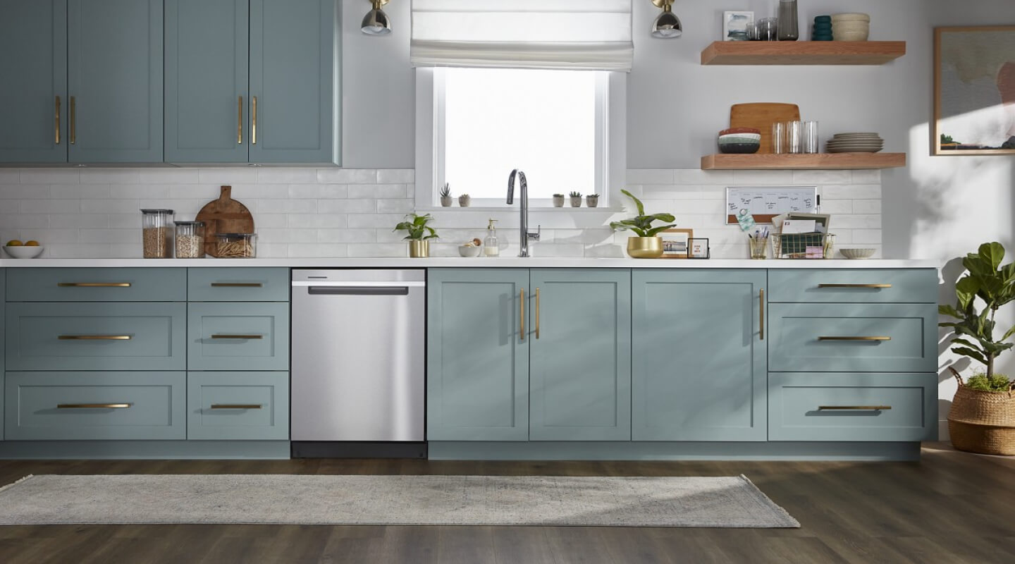 A kitchen with blue cabinets and a stainless steel dishwasher
