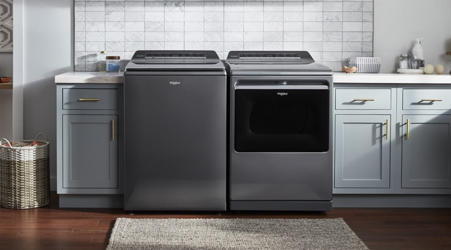 Gray Whirlpool® Top Load Washer and Dryer pair in blue cabinetry