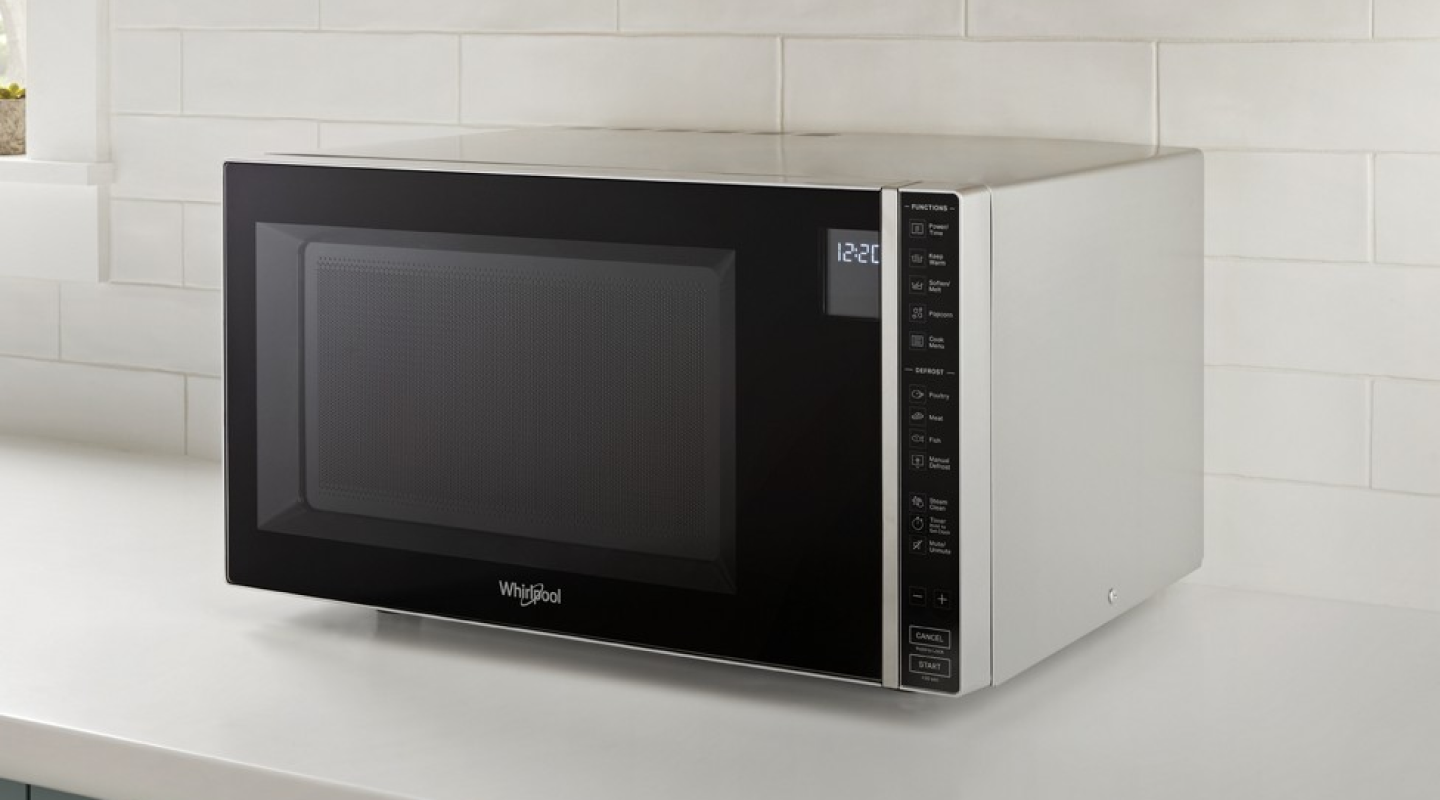 A Whirlpool® Microwave on a white countertop