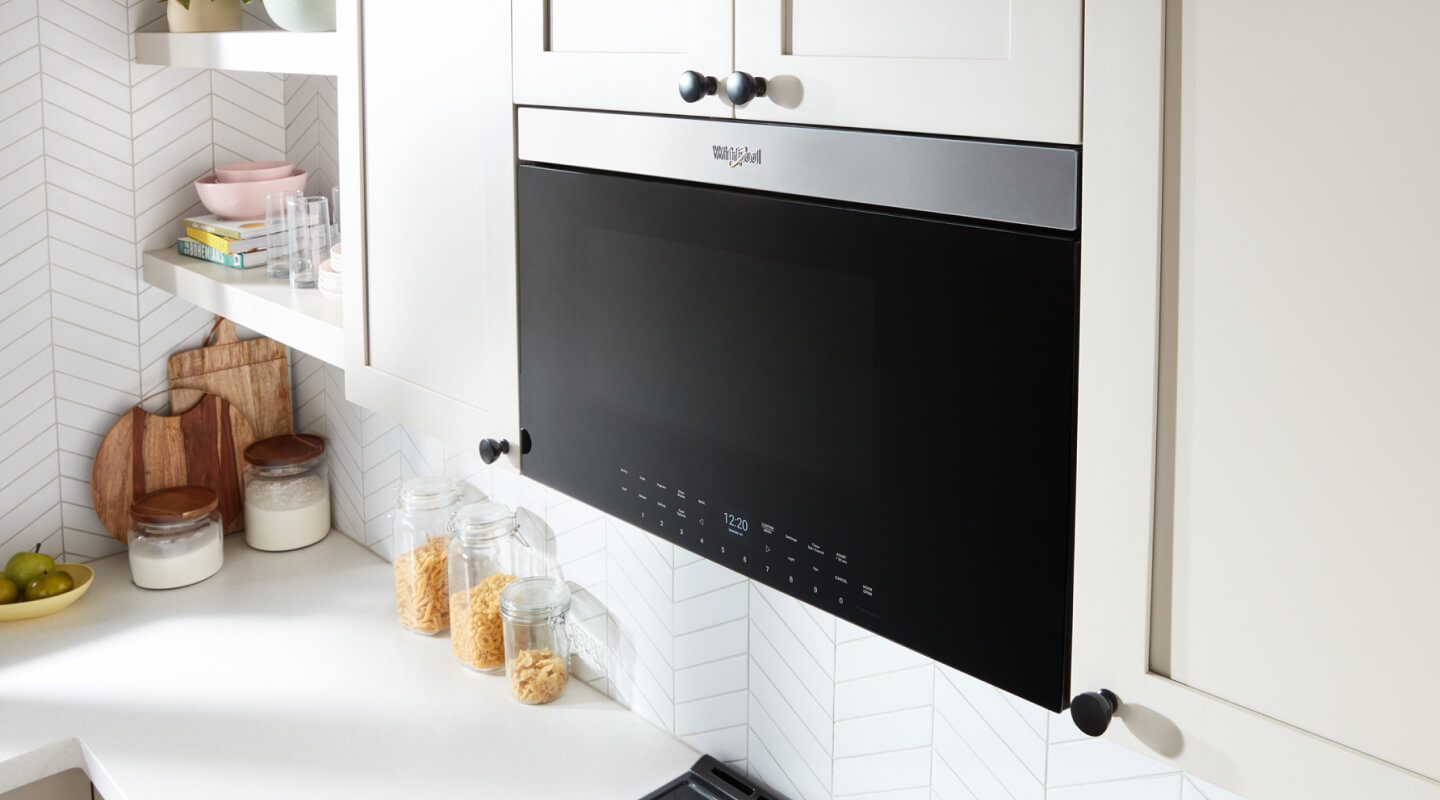 Whirlpool® Air Fry Over-the-Range Microwave Oven in white cabinetry