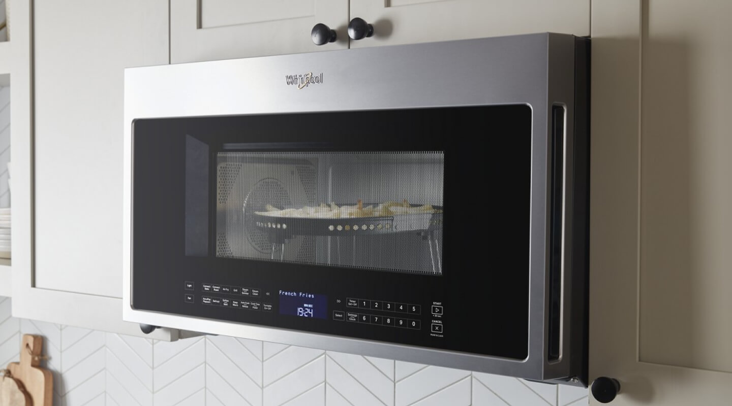 Whirlpool® Air Fry Over-the-Range Microwave with food cooking inside