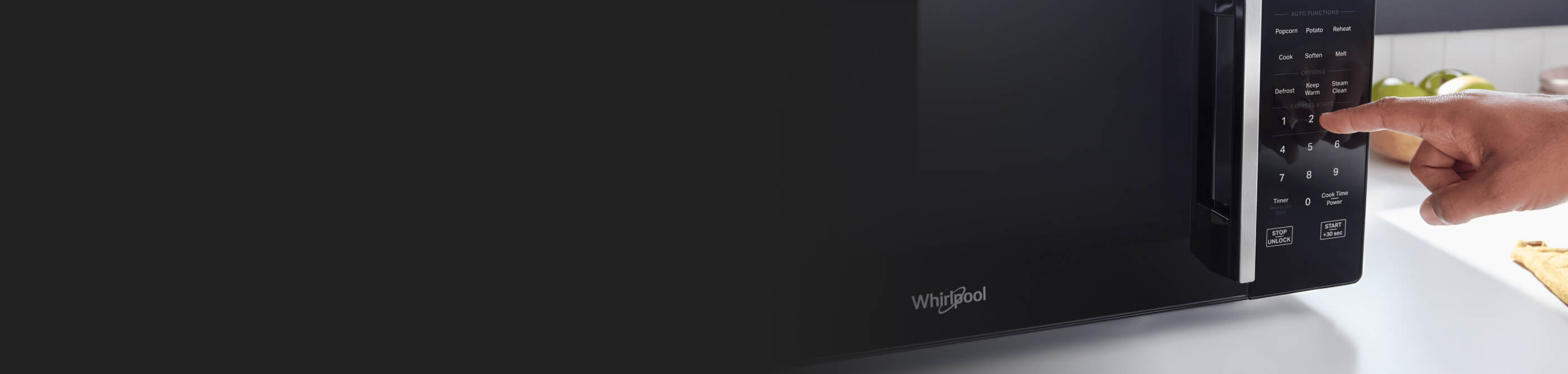 Person selecting a setting on a countertop microwave control panel