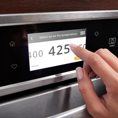 Person setting oven temperature