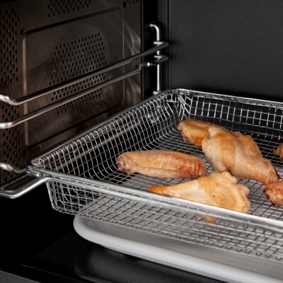 Air fry basket cooking chicken wings in microwave