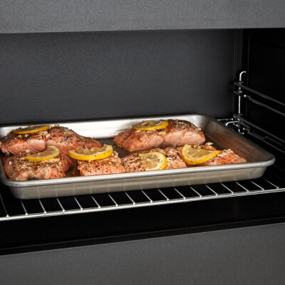 Salmon cooking on a tray inside a convection microwave