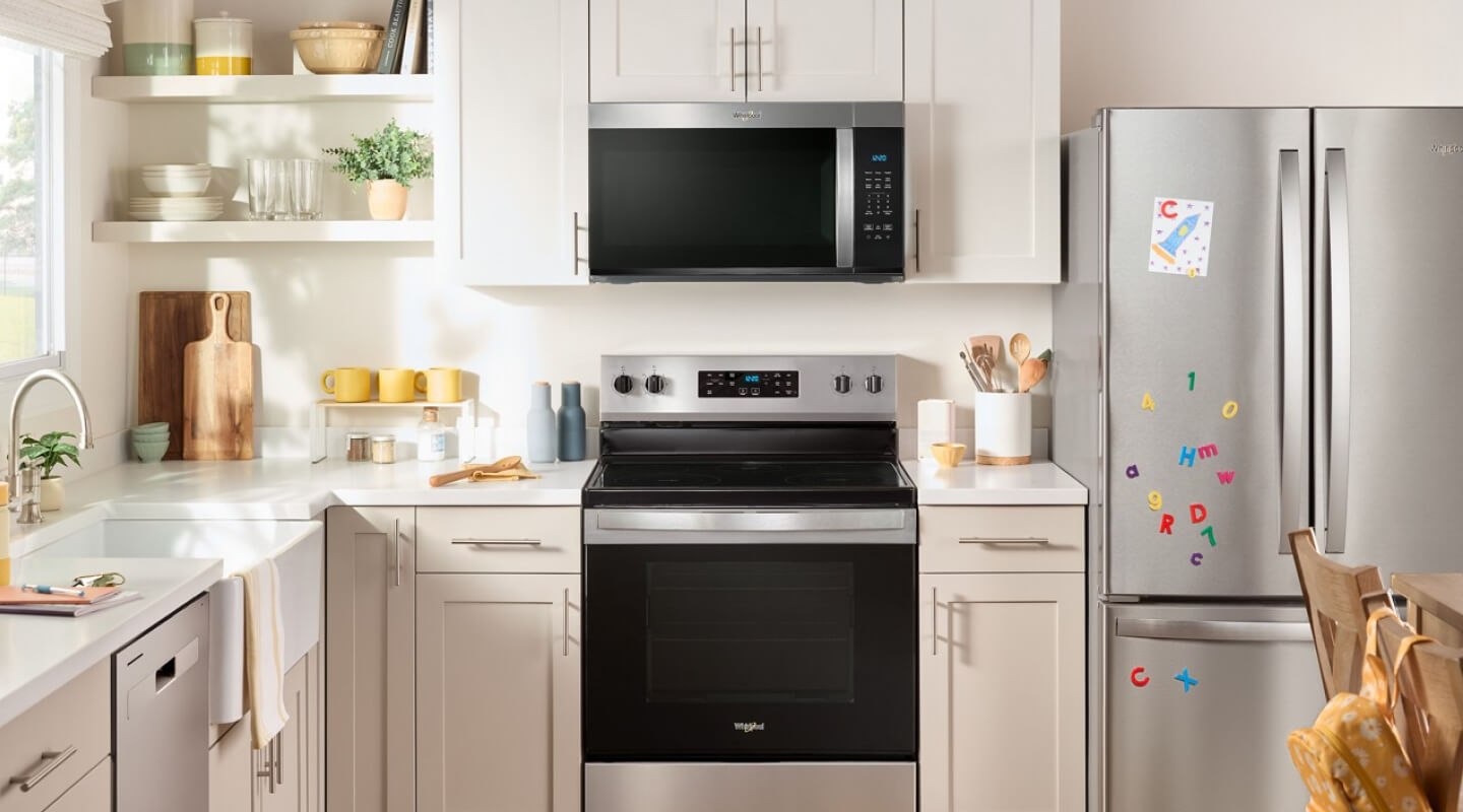 Whirlpool® Over-the-Range Microwave and Electric Range in cream and white cabinetry Whirlpool® Over-the-Range Microwave and Electric Range in cream and white cabinetry