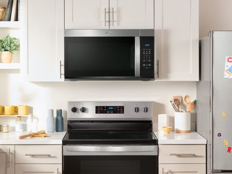 Whirlpool® Over-the-Range Microwave and Electric Range in cream and white cabinetry Whirlpool® Over-the-Range Microwave and Electric Range in cream and white cabinetry