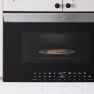 Close-up of food cooking inside an over-the-range microwave