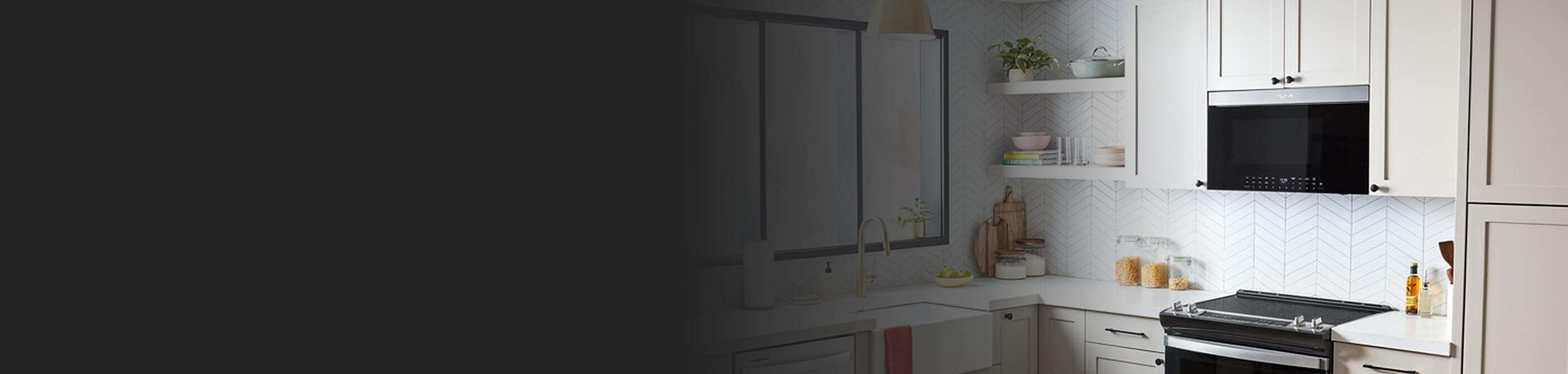 Whirlpool® Over-the-Range Microwave above electric range in white cabinetry