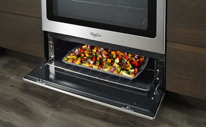 Food in an open broiler drawer