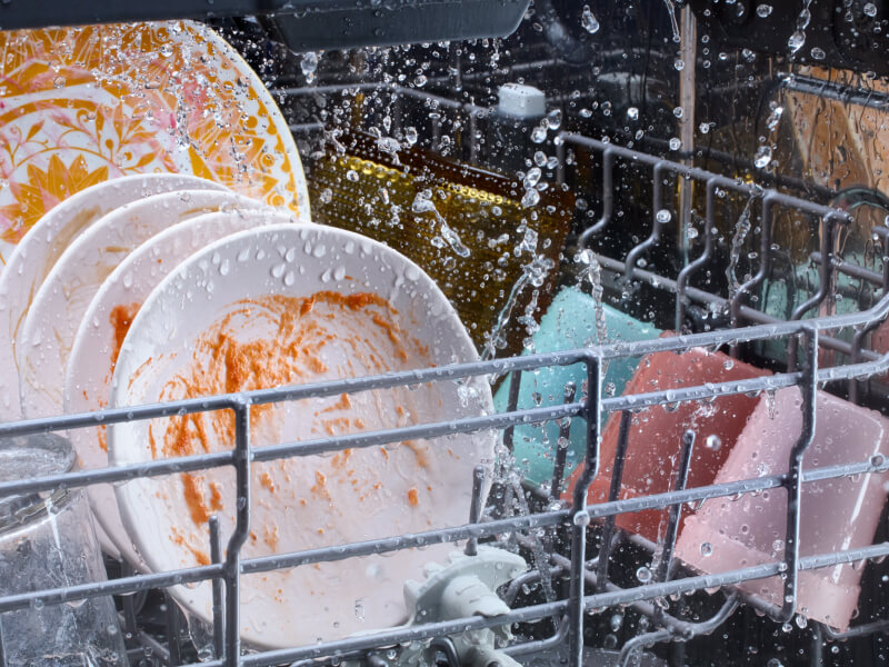 Dirty dishes washing in a dishwasher Dirty dishes washing in a dishwasher