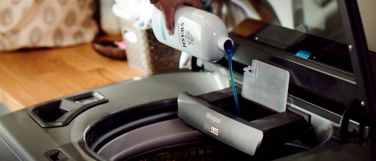 Swash™ Laundry Detergent being poured into a Load & Go™ Dispenser Swash™ Laundry Detergent being poured into a Load & Go™ Dispenser
