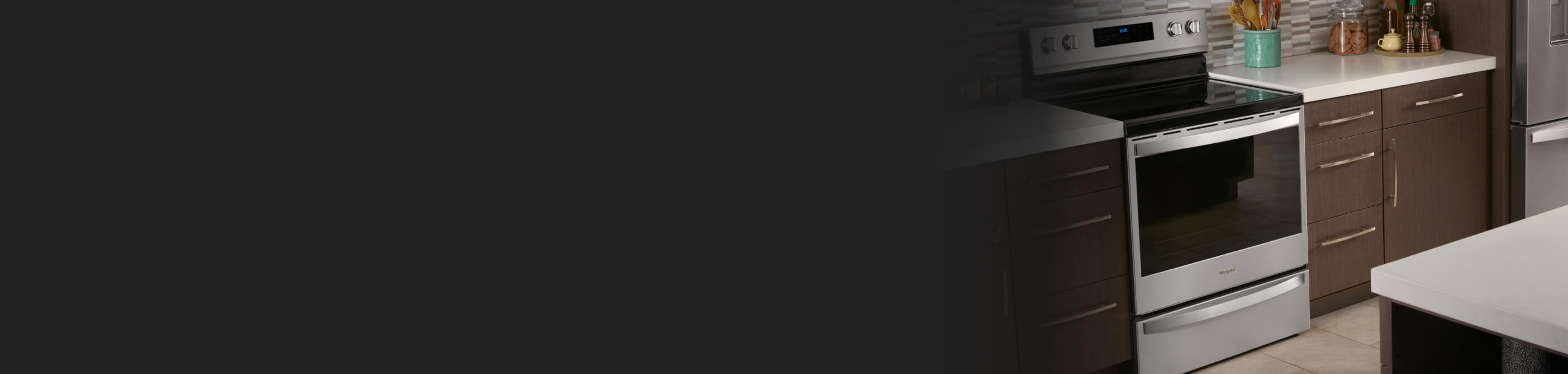 Whirlpool® Electric Range set in brown cabinetry