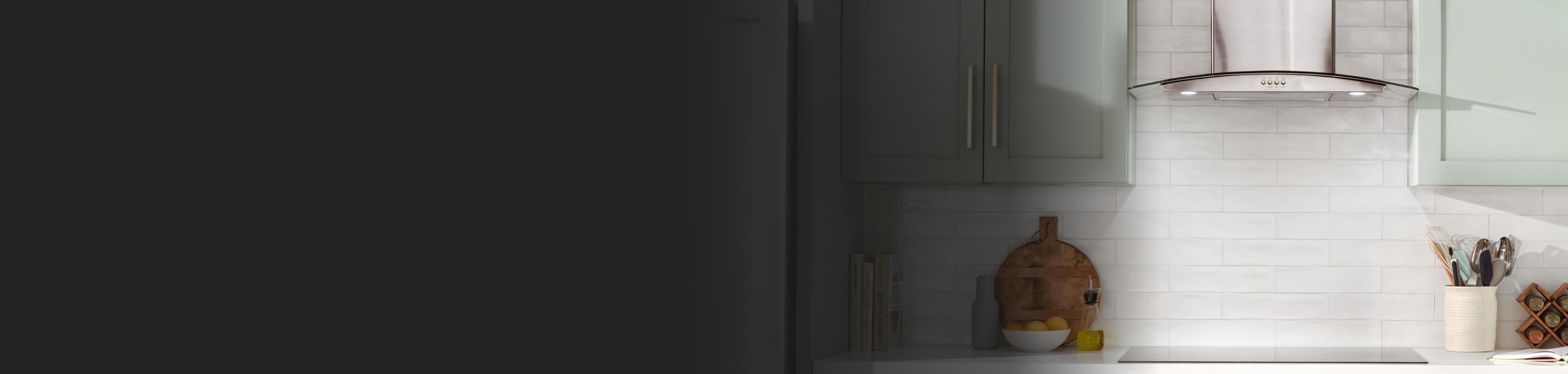 A range hood between teal cabinets